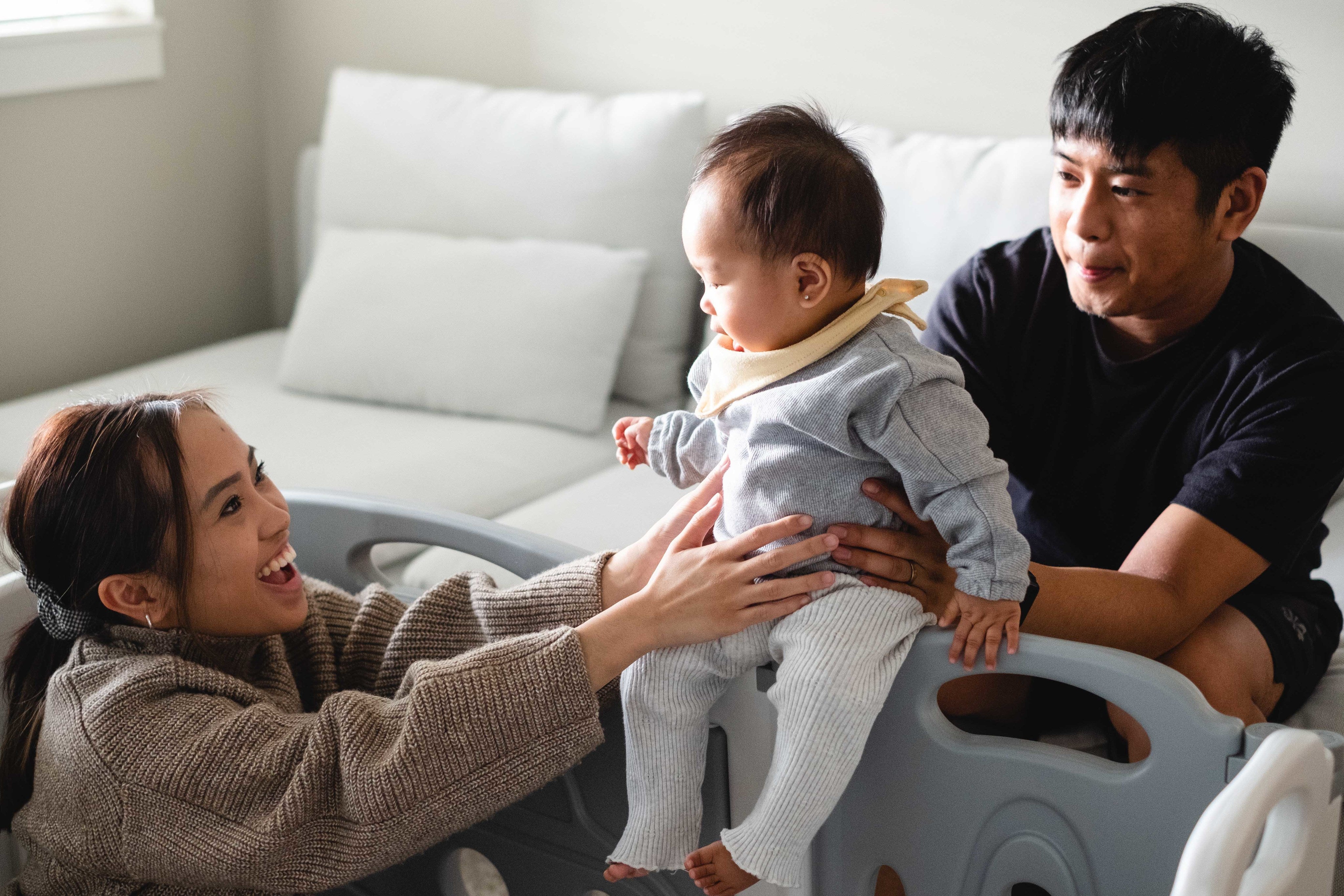 files/a-mother-smiles-as-a-father-holds-their-baby.jpg